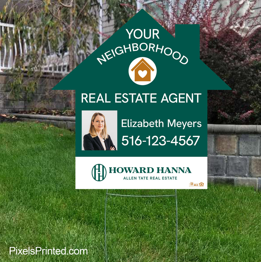 A real estate agent's house-shaped yard sign positioned near a sidewalk for maximum visibility.