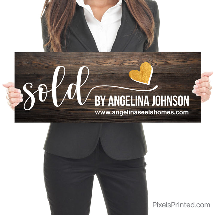 closing photo sign with homeowners sold by realtor with gold heart
